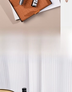 Detail of woven brown leather storage tray with premium metal handle and modern texture