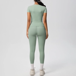 Back view of a bean green yoga set featuring a tight short sleeve tee and high waist leggings