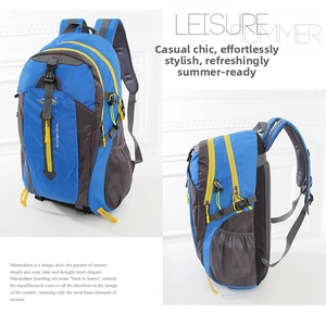 Detail of blue outdoor backpack featuring multi-layer zip pockets and yellow accents