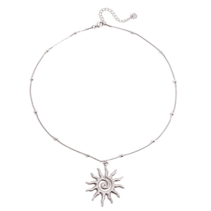 Detail of silver snake chain necklace with small beads and spiral sun pendant