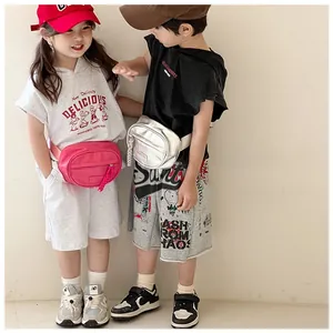 Detail view of pink and silver children's fanny packs with colorful zipper pullers
