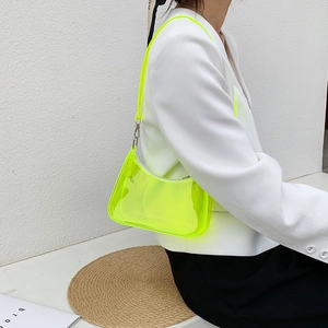Neon yellow transparent PVC jelly shoulder bag stylishly worn for summer fashion