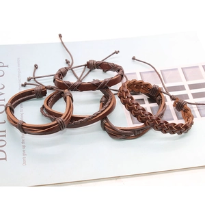 Detail view of five-piece vintage brown leather and braided rope men's bracelet set