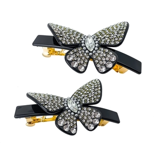 Elegante coppia di fermagli per capelli a farfalla con cristalli e base in metallo dorato