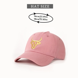 Close-up of pink baseball cap featuring gold bull embroidery and hat size measurements
