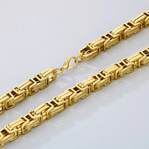 Close-up of golden Byzantine chain links with a secure lobster clasp and polished finish