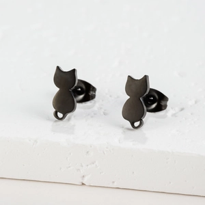 Macro shot of minimalist matte black stainless steel cat silhouette stud earrings