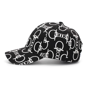 Detail view of digital print baseball cap with monochromatic monogram pattern and curved brim
