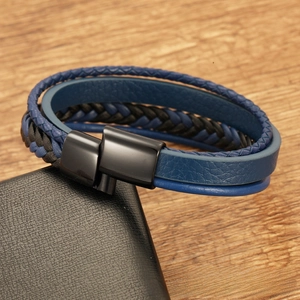 Detail of multi-layer woven blue and black leather bracelet with black metal magnetic clasp