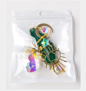 Detail of agate suncatcher in packaging with golden moon and crystal prism ball
