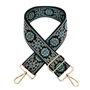 Detail of adjustable floral jacquard bag strap with golden zinc alloy lobster clasps