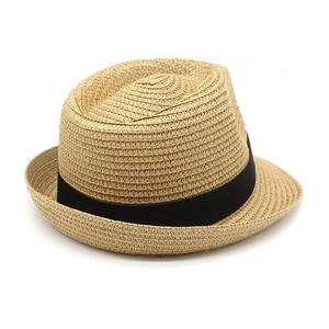 Close-up of natural straw Panama hat with a wide black grosgrain ribbon detail