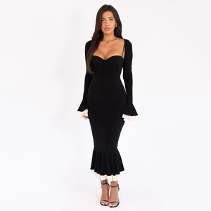 Detailed view of women's black bodycon dress featuring white ruffled cuffs and hemline