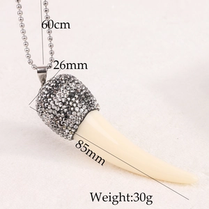 Detailed view of resin tusk pendant necklace with dark grey rhinestones and size labels