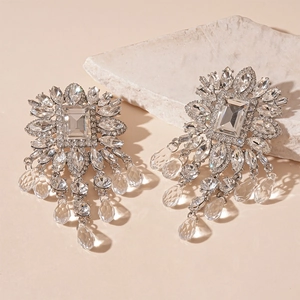 Detailed close-up of luxury flower diamond earrings with crystal fringe and silver needles