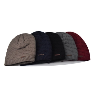 Detail of 5 knit beanies showing ribbed texture and leather patch in multiple colors