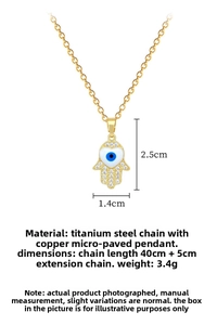 Macro view of gold Hamsa hand pendant with evil eye motif and micro-pave zircons