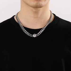 Close-up of a 10mm silver Cuban link necklace with a diamond-set clasp on a male model