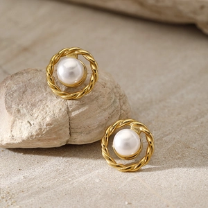 Elegant gold twisted hoop earrings featuring round white pearls on a natural stone base