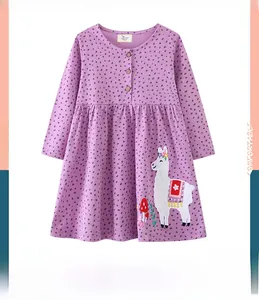 Close-up of girl's purple dress with polka dots and detailed white llama embroidery