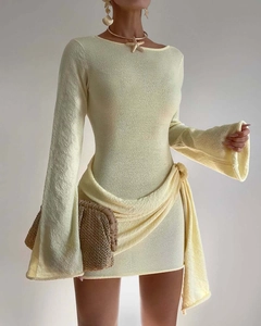 Detail of light yellow knit dress with long flared sleeves and a waist tie closure