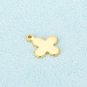 Golden stainless steel hollow cross pendant with clover design on a light blue background