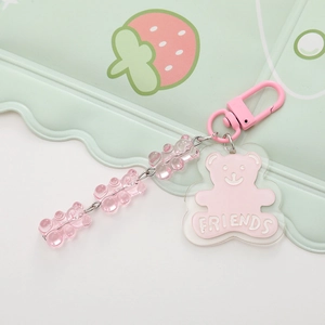 Pink acrylic bear keychain with resin beads and Friends text on a decorative plate
