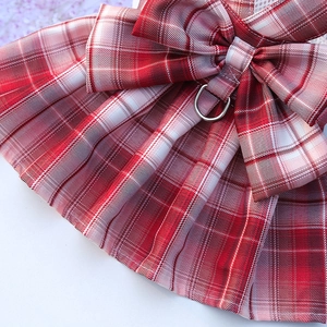 Detail of red and white checkered pet JK dress with bow and metal D-ring attachment