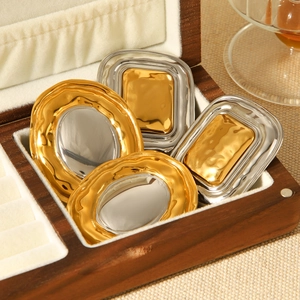 Two-tone geometric stainless steel earrings set in a wooden jewelry box