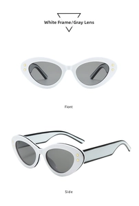Detail of white cat eye sunglasses with gray lenses and gold star accents on the frame