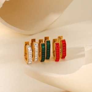 Macro detail of U-shaped stainless steel hoop earrings with baguette-cut zircon inlay