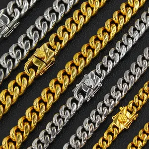 Detail of gold and silver cuban link chains with square clasp on black leather