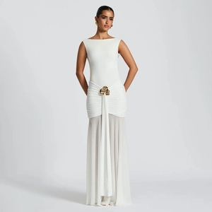 Detail of white sleeveless maxi dress with gold waist buckle and pleated chiffon fabric