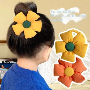 Detail of cute fabric flower hair ties showing yellow and orange floral designs