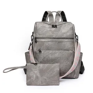 Vintage grey faux leather backpack set with colorful ethnic embroidered guitar strap