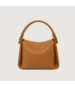 Detailed view of brown litchi pattern leather texture on soft large capacity pillow bag