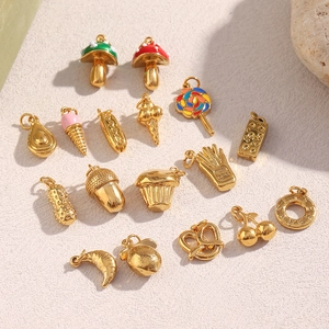 Detail of 18K gold plated food charms like mushroom, croissant and ice cream shapes