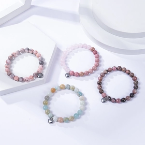 8mm natural stone beaded bracelets with heart pendants on geometric display stands