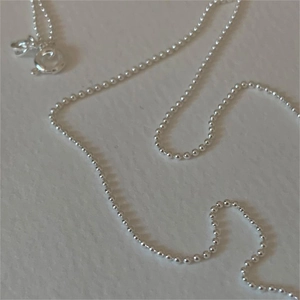 Detail shot of minimalist 925 sterling silver bead chain necklace with smooth round beads