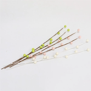 Detail showing artificial berries in green, pink, and white for home floral decoration