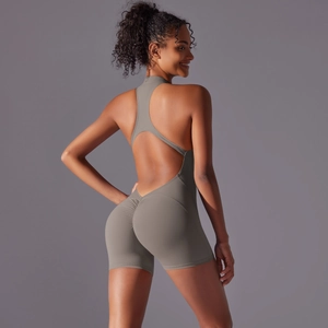 Detail of grey athletic bodysuit featuring cross back straps and scrunch butt lifting design