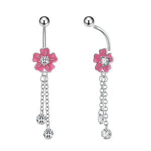 Detailed macro view of silver belly ring featuring pink enamel flower and zircon tassels