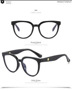 Detail of black oversized glasses frame with gold circular metal accents on temples