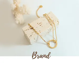 Detail of 18K gold-plated asymmetrical chain bracelet with rectangle links and beads