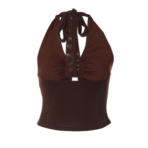 Detail view of brown halter neck top with matte and shimmer glitter fabric patchwork
