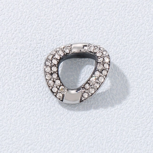 Macro detail of silver irregular geometric pendant with shimmering pavé crystal inlay