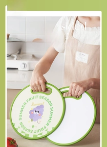 Close-up of double-sided fruit cutting board with anti-slip edges and hanging hole