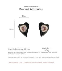 Detail view of heart-shaped earrings with black enamel and zircons, size 1.5cm by 2.3cm