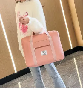 Pink waterproof nylon travel bag with front pocket and double handles for gym or short trips