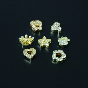 Close-up of DIY gold plated letter and shape sliders with sparkling rhinestones detail